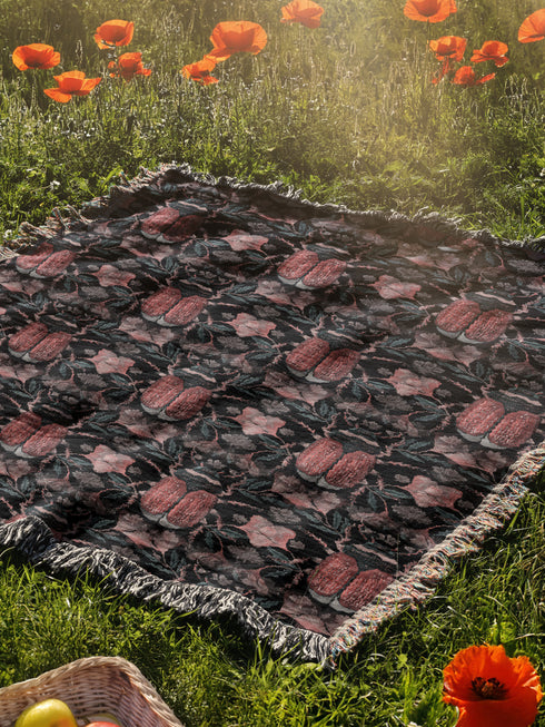 Luxurious woven cotton throw blanket featuring symmetrical scarab beetle pattern in terracotta on black background with white fringe detail. Perfect as gothic wall tapestry, dark academia decor, or cottagecore blanket for bedroom or living room.